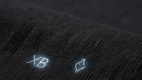 Dein Premium Rock T-Shirt von XXCESSIVEBLACK - Detailaufnahme der 100% gekämmten Baumwolle mit feinem XB-Logo.