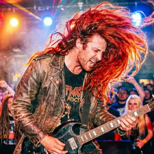 Rocker mit langen roten Haaren beim Konzert.
