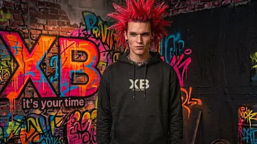 Rothaariger Punk trägt hochwertigen schwarzen Heavyweight Premium Rock Hoodie mit einer Grammatur von 350g/m² sowie XB-Design aus Öko-Tex zertifizierten Farben.